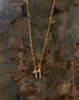 Solid 14k gold paperclip chain necklace with a small diamond 11 pendant at the center. Against a labradorite crystal.