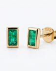 Solid 24k Gold stud earrings with a 585 stamp. Each emerald is an emerald cut, and in a 14k gold bezel setting, with a post back