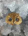 A Gold Vermeil textured feather owl ring, inspired by Athena. Against a crystal background