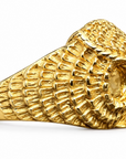 A side view of the Athena owl ring, showing off the feather detailing going around the sides, as well as the feathered eye feature. Against an amethyst crystal background.