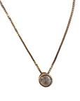 A delicate sterling silver plated gold chain necklace with a small round bezel-set cubic zarconia pendant, shown against a plain white background.