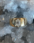Thick 14k yellow gold ring, with a prong set hexagon diamond against a crystal background