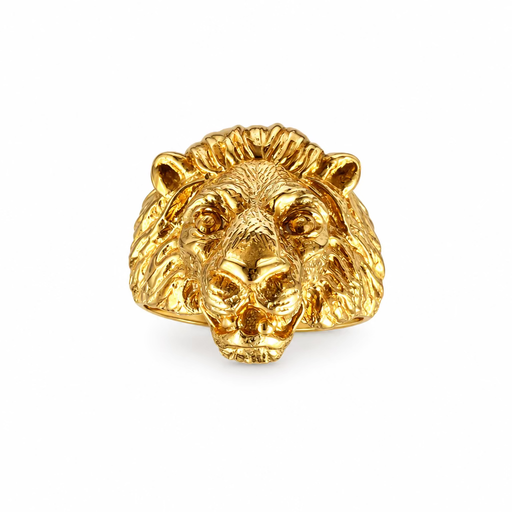 Front view of the face of the lion in the Aslan King of Beasts Gold Vermeil Lion ring. Showing the detail in the face and mane, and powerful gaze. Against a crystal background.