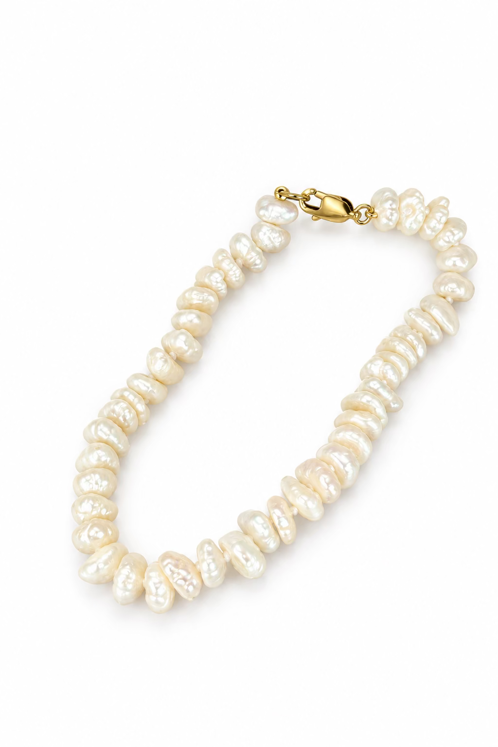 A white organic-shaped pearl bracelet with a gold clasp, with a white background.
