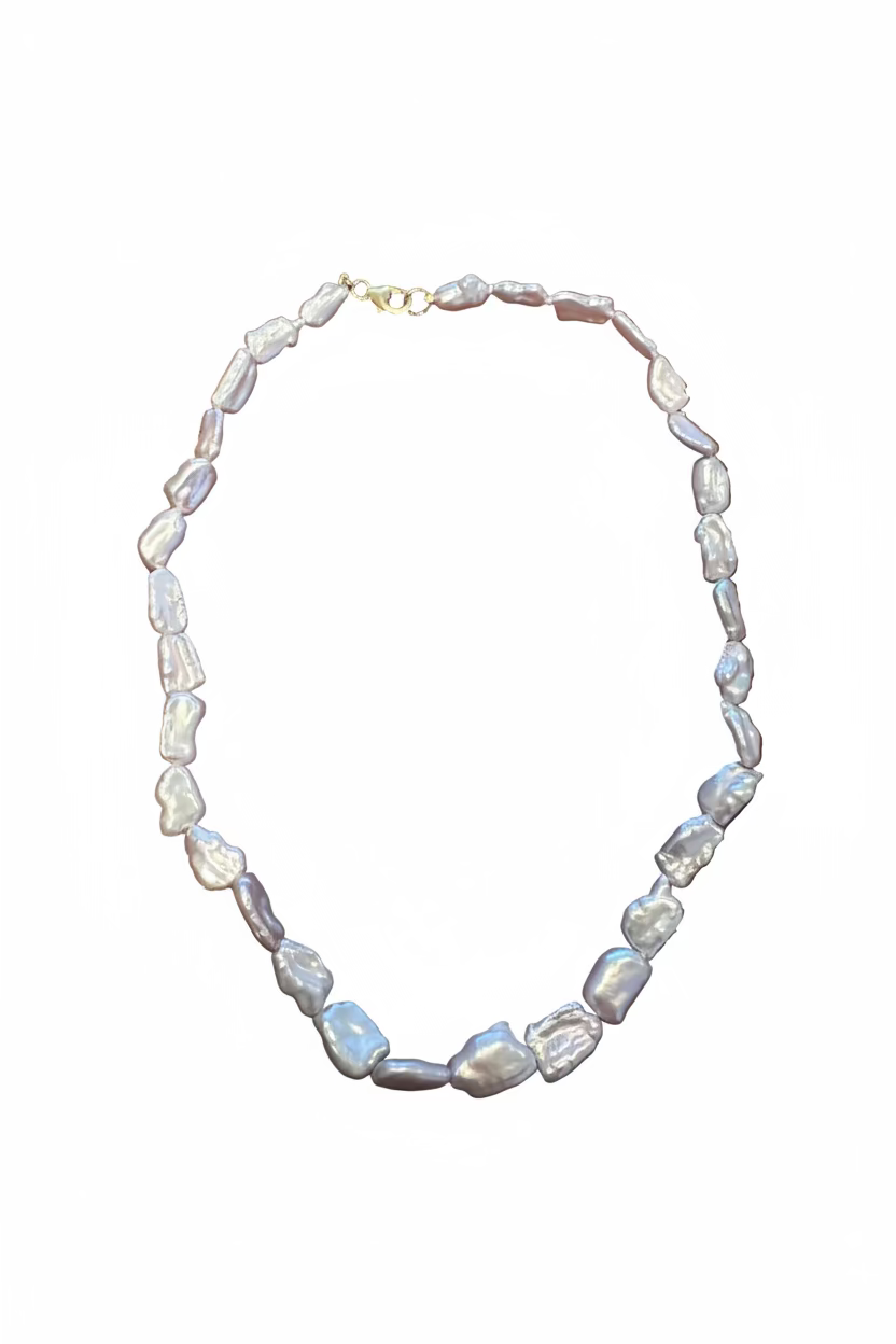 A baroque pearl necklace with a gold clasp, with a white background.