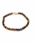 A 6 inch hand-beaded bracelet. Featuring brown and black Tiger's Eye beads with a small gold-filled clasp, against a white background. 