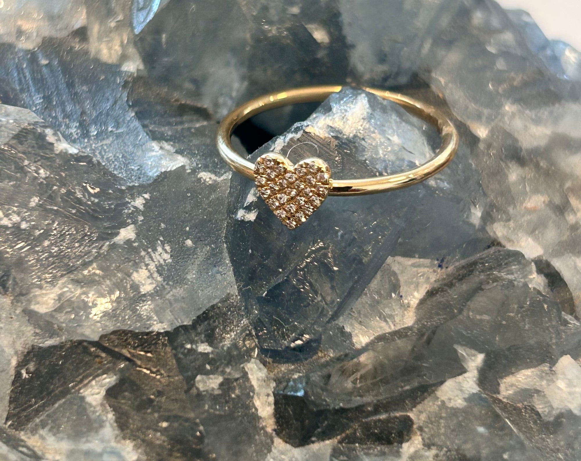 Delicate solid 14k gold heart-shaped ring with pave diamonds on a crystal. 