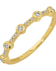 Solid 14k yellow gold with 5 bezel set diamonds stationed evenly throughout, with smaller pave diamonds in between the gaps. Inside is stamped '14k 585', and it is displayed on a white background. 
