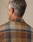 A detailed shot of the collar from behind of a blue, grey, beige, brown, and redish plaid button down shirt. It is the Faherty Legend Sweater Shirt in boulder creek plaid. 
