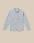 A light blue and white striped organic  cotton long-sleeve button-down shirt with a classic collar and chest pocket, laid flat against a solid beige background.