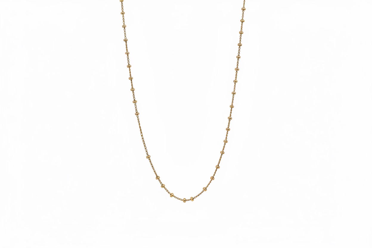 A delicate gold vermeil chain necklace with small, evenly spaced round beads, displayed against a white background. 