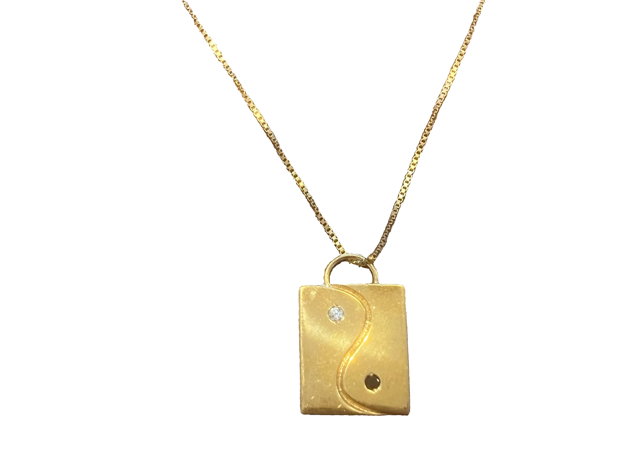 A gold vermeil pendant necklace featuring a rectangular yin-yang charm designed by Jacquline Nicole Brown, a small clear stone made from cubic zarconia, and a black cubic zarconia gemstone, suspended on a delicate gold box chain against a white background.