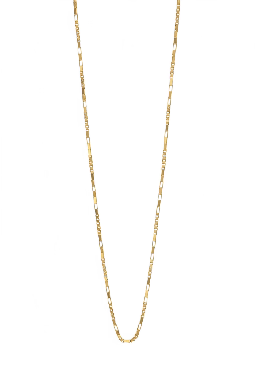 A delicate and unique solid 14k gold box chain necklace laid flat on a white surface