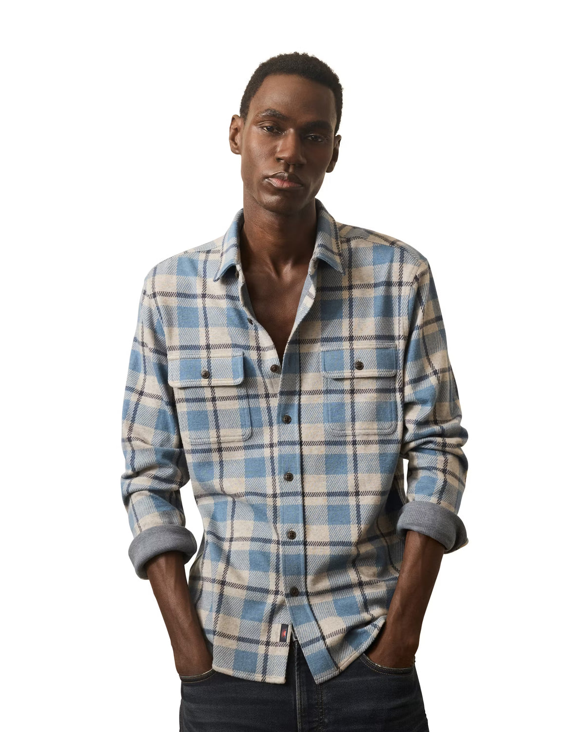 Man wearing a Faherty Legend Sweater Shirt in Overcast Ocean Plaid with blue, grey, and beige plaid shirt on a white background