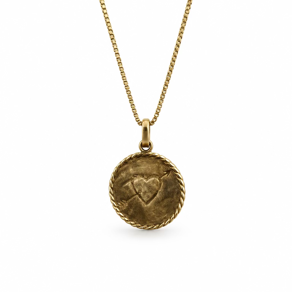 The backside of the love necklace, showcasing a heart with an arrow through it. This gold vermeil pendant is on a box chain against a white background.