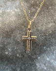 A solid 14k gold cross pendant necklace with 16 diamonds inlaid in the center, on a 16 inch paperclip chain necklace. 