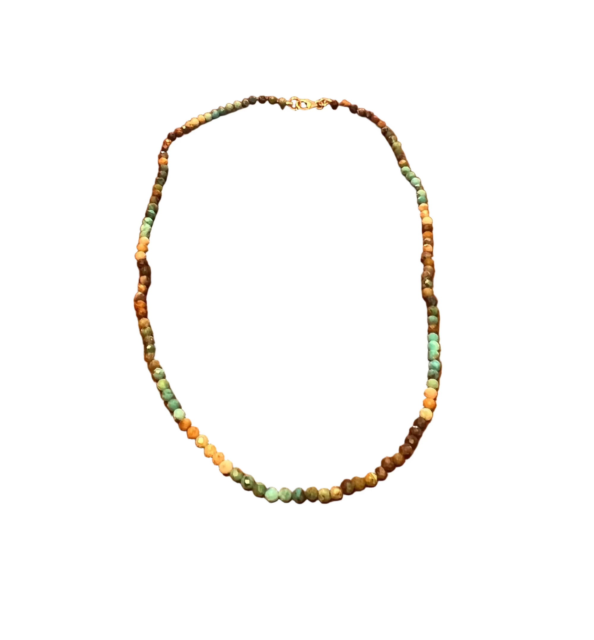 A beaded necklace with small turquoise, brown, and cream beads, displayed on a white surface.