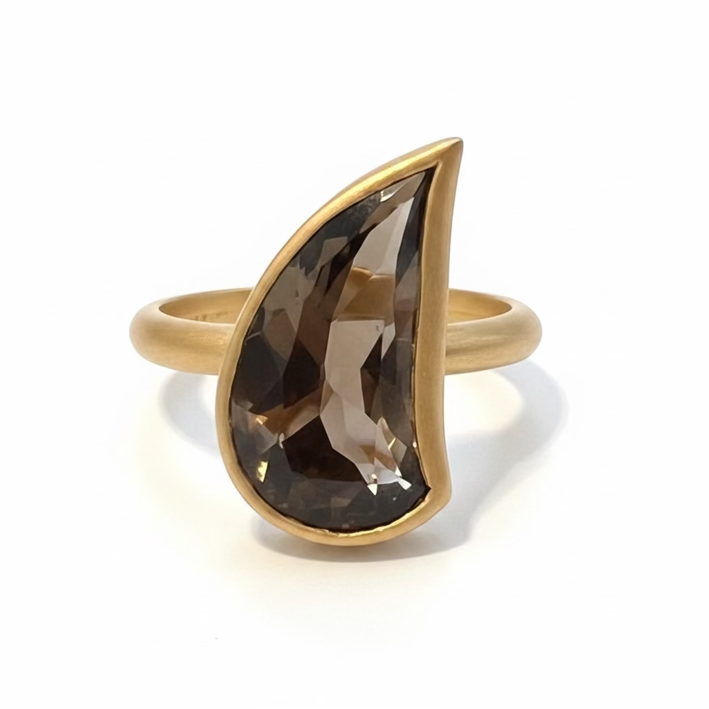 A 14k gold ring featuring a large, teardrop-shaped dark brown smoky topaz gemstone, displayed against a white background.