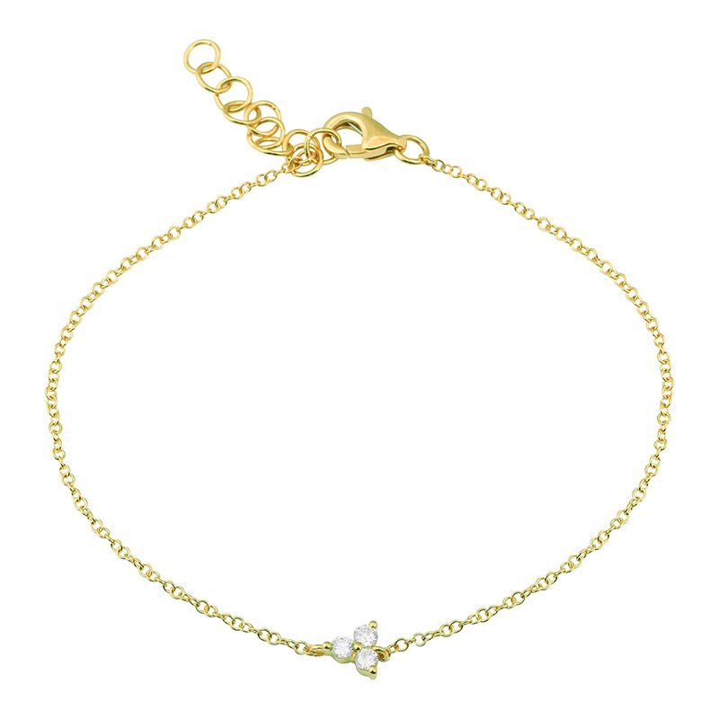 A solid 14k yellow gold bracelet, with three diamonds in a floral cluster. A 5.5 inch gold cable chain with a 1 inch extender. 