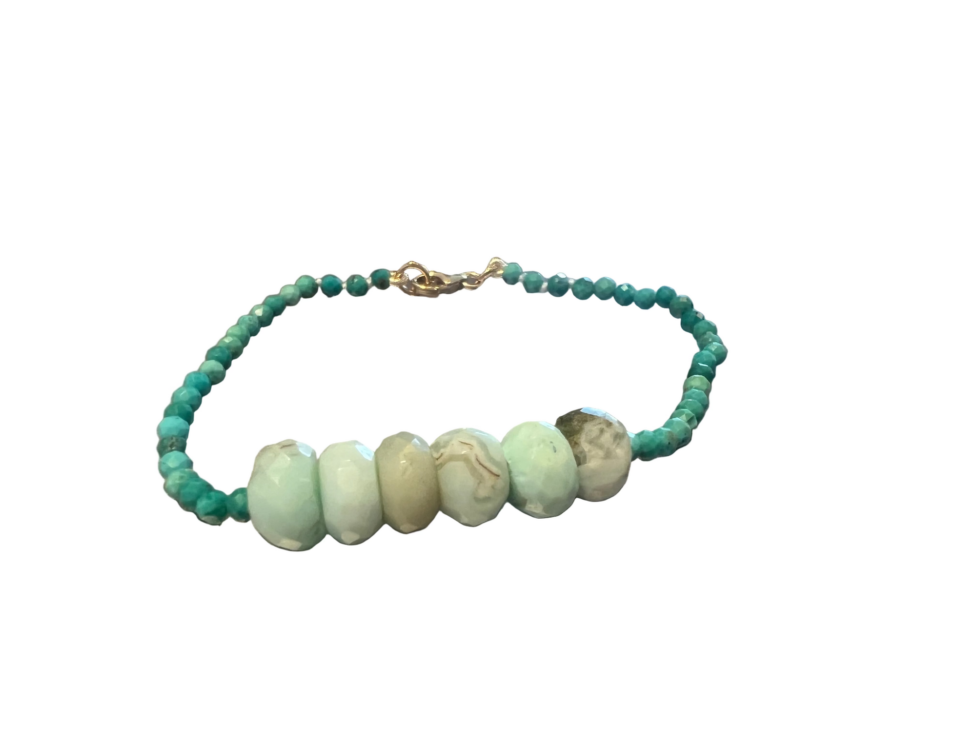 A beaded bracelet with turquoise green round beads and five larger marbled pale green chrysoprase beads, displayed against a white background.