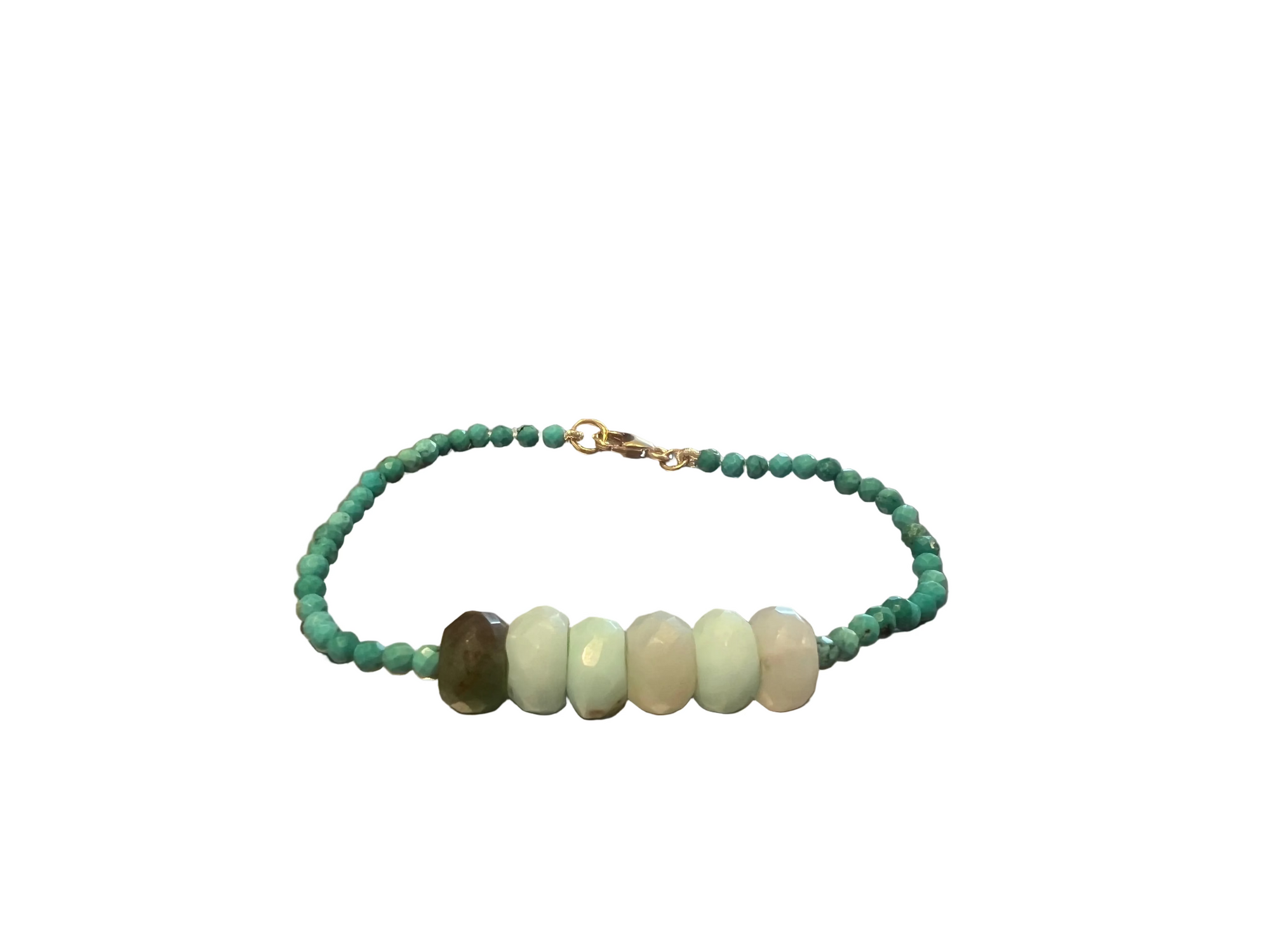 A beaded bracelet with turquoise green beads and six large pale green chrysoprase stone beads in the center, displayed against a white background.