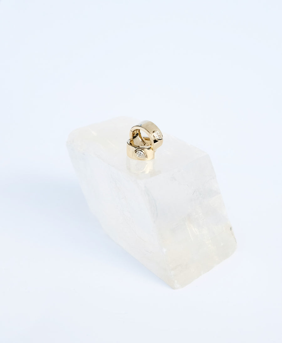 Teardrop Huggies pave set (peat-shape) diamond on wide 14k  yellow gold band.