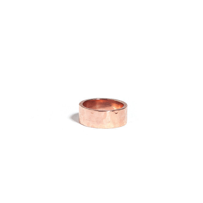 A rose gold vermeil hammered cigar band against a white background.