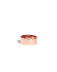 A rose gold vermeil hammered cigar band against a white background.